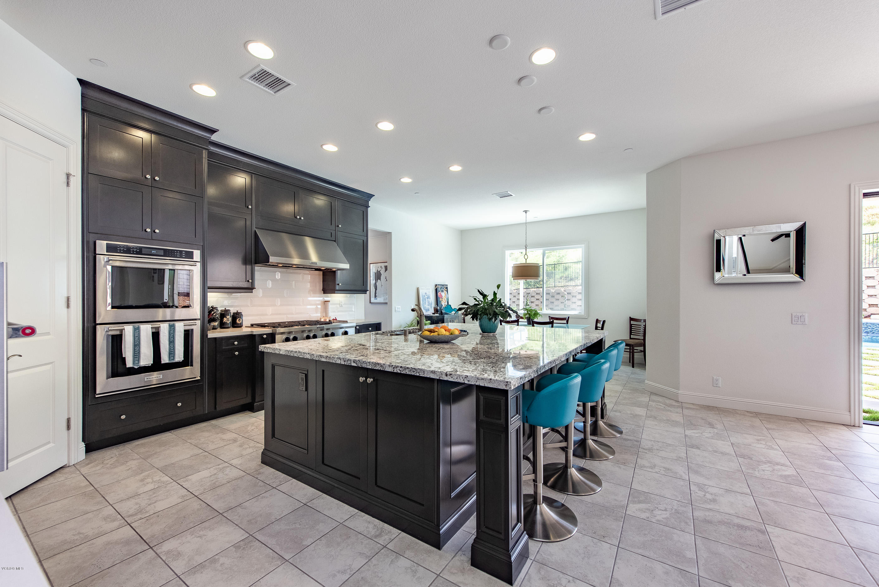 11276 Crenshaw Street Moorpark, CA 93021 - Photo 18 of 52 a kitchen with stainless steel appliances granite countertop a table and chairs