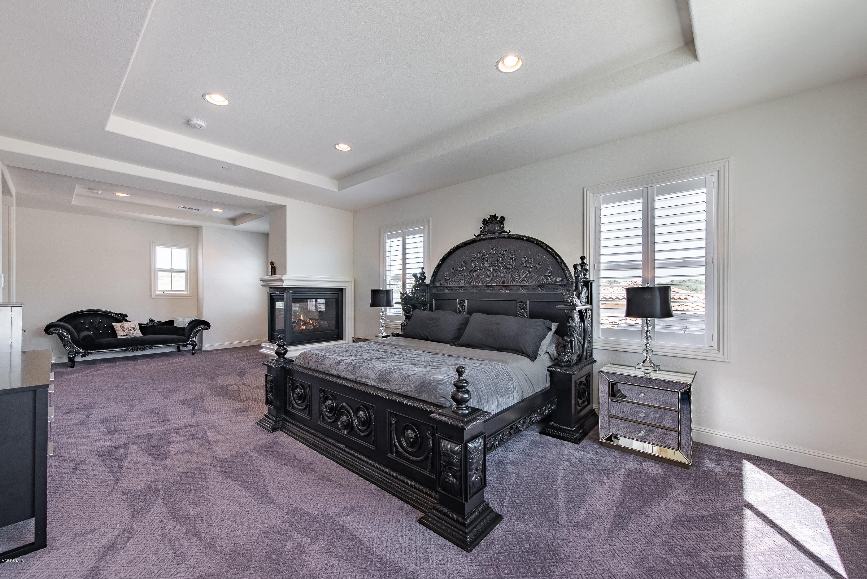 11276 Crenshaw Street Moorpark, CA 93021 - Photo 26 of 52 a spacious bedroom with a bed a table and potted plant with the wooden floor