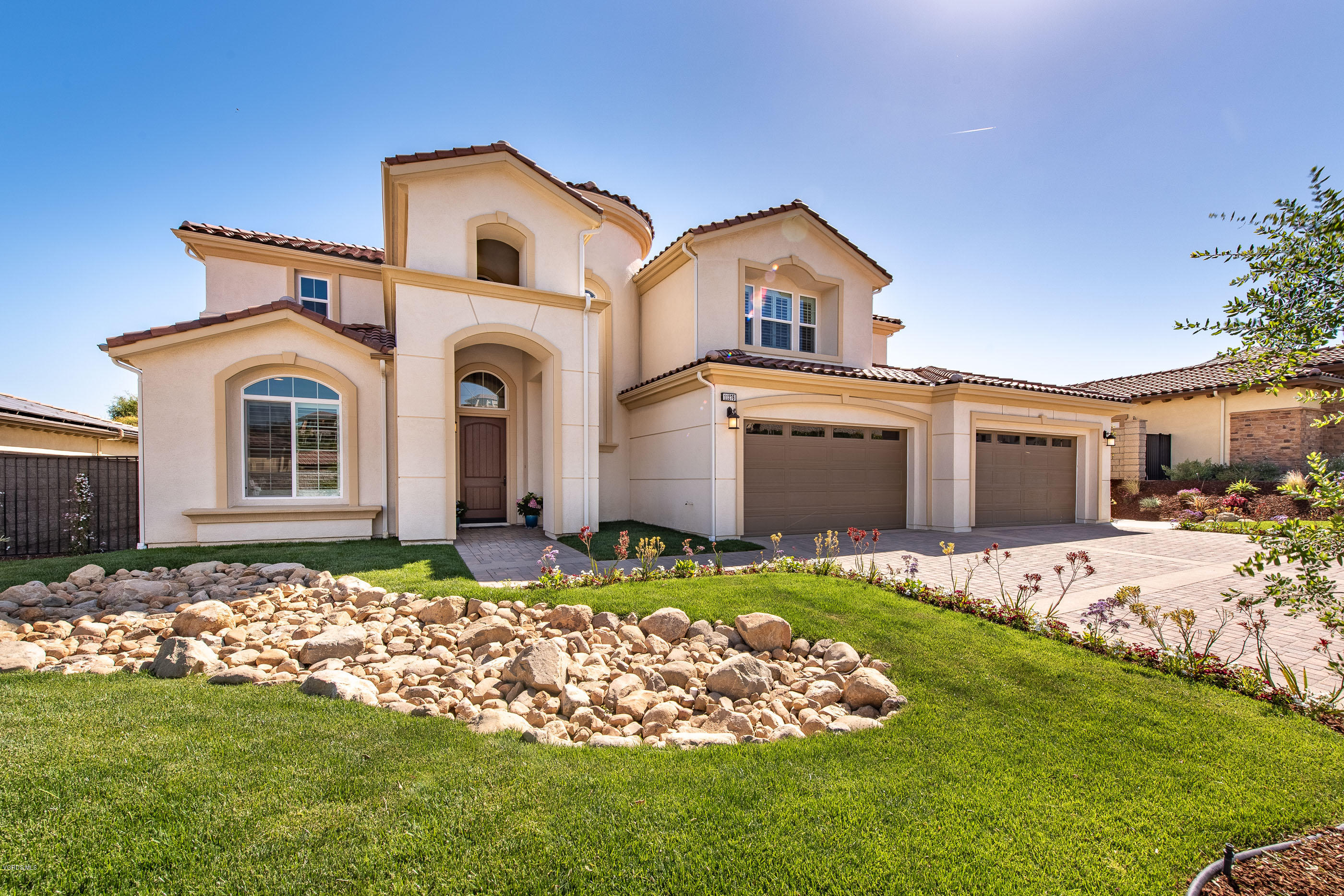 11276 Crenshaw Street Moorpark, CA 93021 - Photo 4 of 52 a front view of a house with a garden and plants