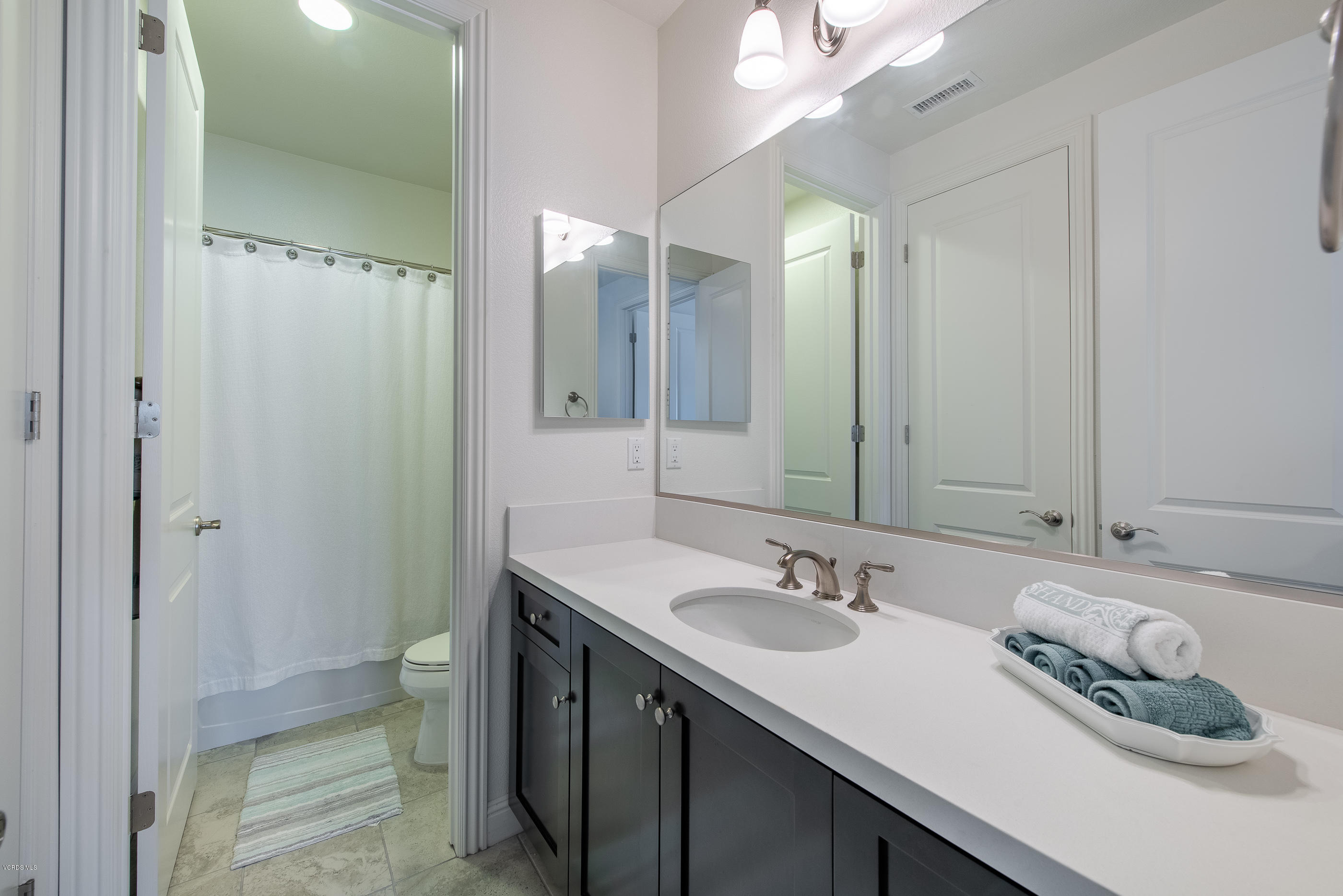 11276 Crenshaw Street Moorpark, CA 93021 - Photo 42 of 52 a bathroom with a granite countertop sink and a mirror