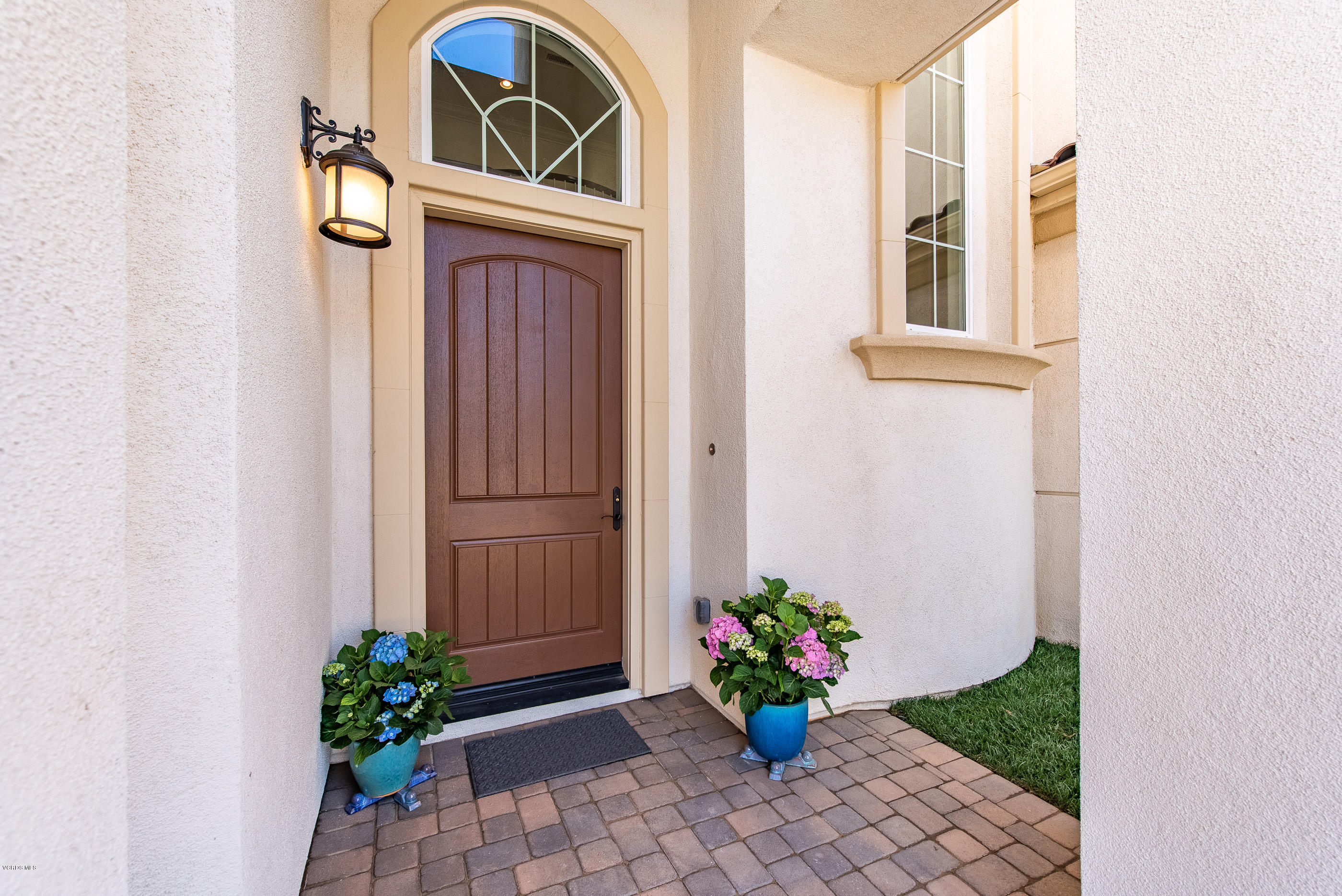 11276 Crenshaw Street Moorpark, CA 93021 - Photo 6 of 52 a vase with flowers sitting on a floor in front of a door