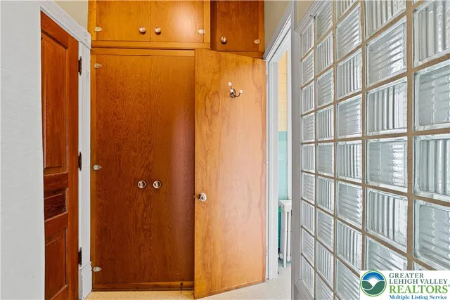 view of a bathroom with a shower and a window