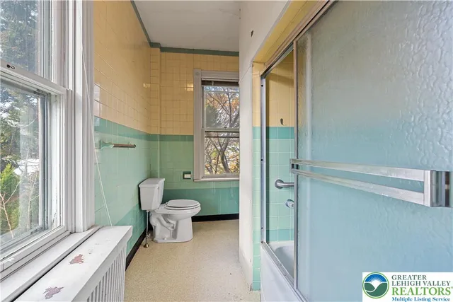 a bathroom with a toilet sink and shower