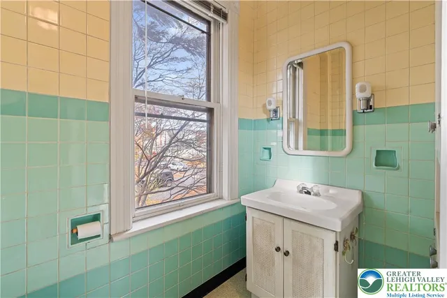 a bathroom with a sink a mirror and a shower