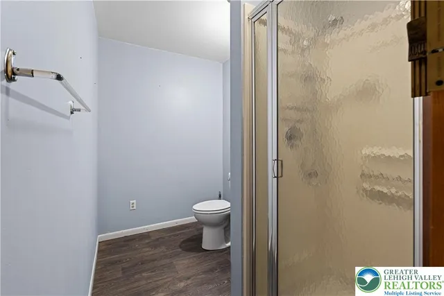 a view of a yard with plants and trees