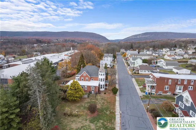 an aerial view of a house with a garden
