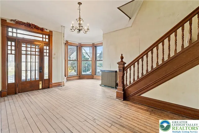 a view of a room with wooden floor and windows