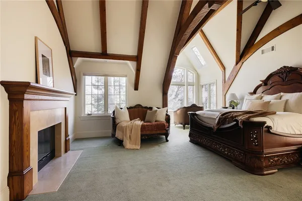 a living room with furniture a fireplace and a large window