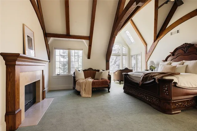 a living room with furniture a fireplace and a large window