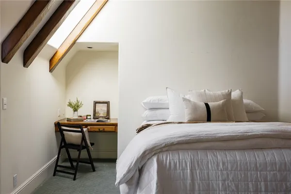 a bedroom with a bed and a table in it
