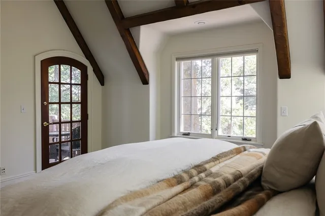 a bedroom with a bed next to a window