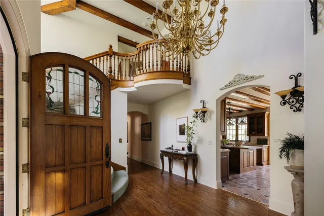 a view of a livingroom with furniture hardwood floor and a kitchen