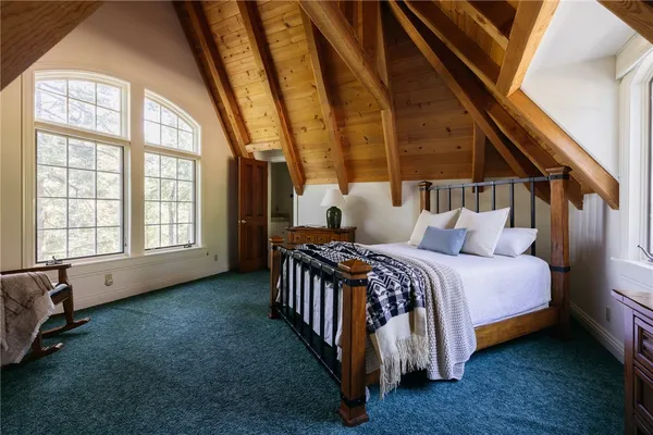 a bed sitting in a bedroom next to a window