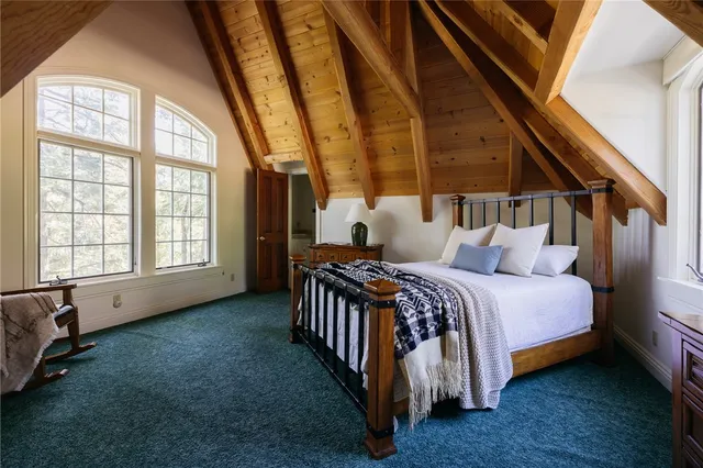 a bed sitting in a bedroom next to a window