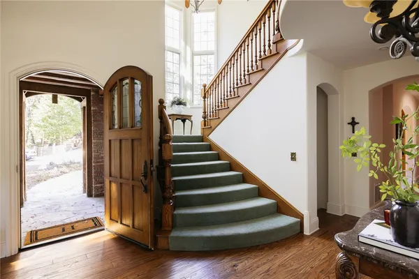 a view of entryway with wooden floor and stairs