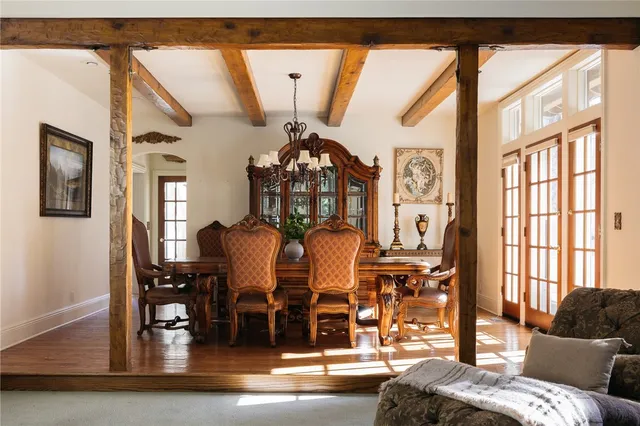 a living room with furniture and floor to ceiling windows