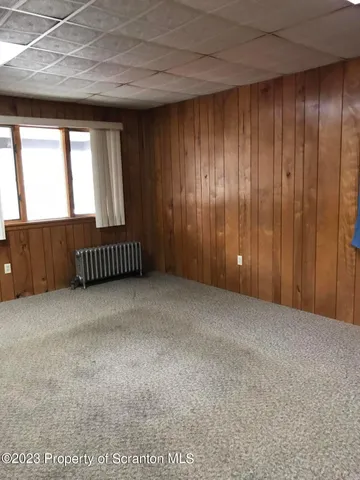 a view of an empty room with wooden walls