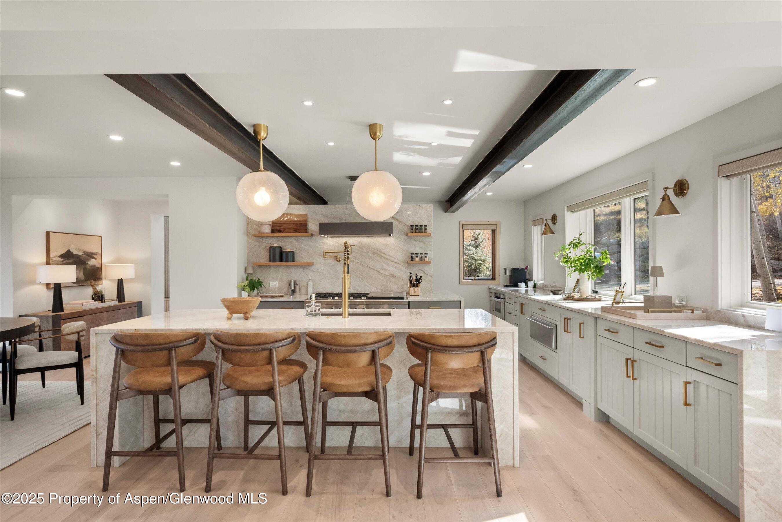 a large kitchen with a table and chairs