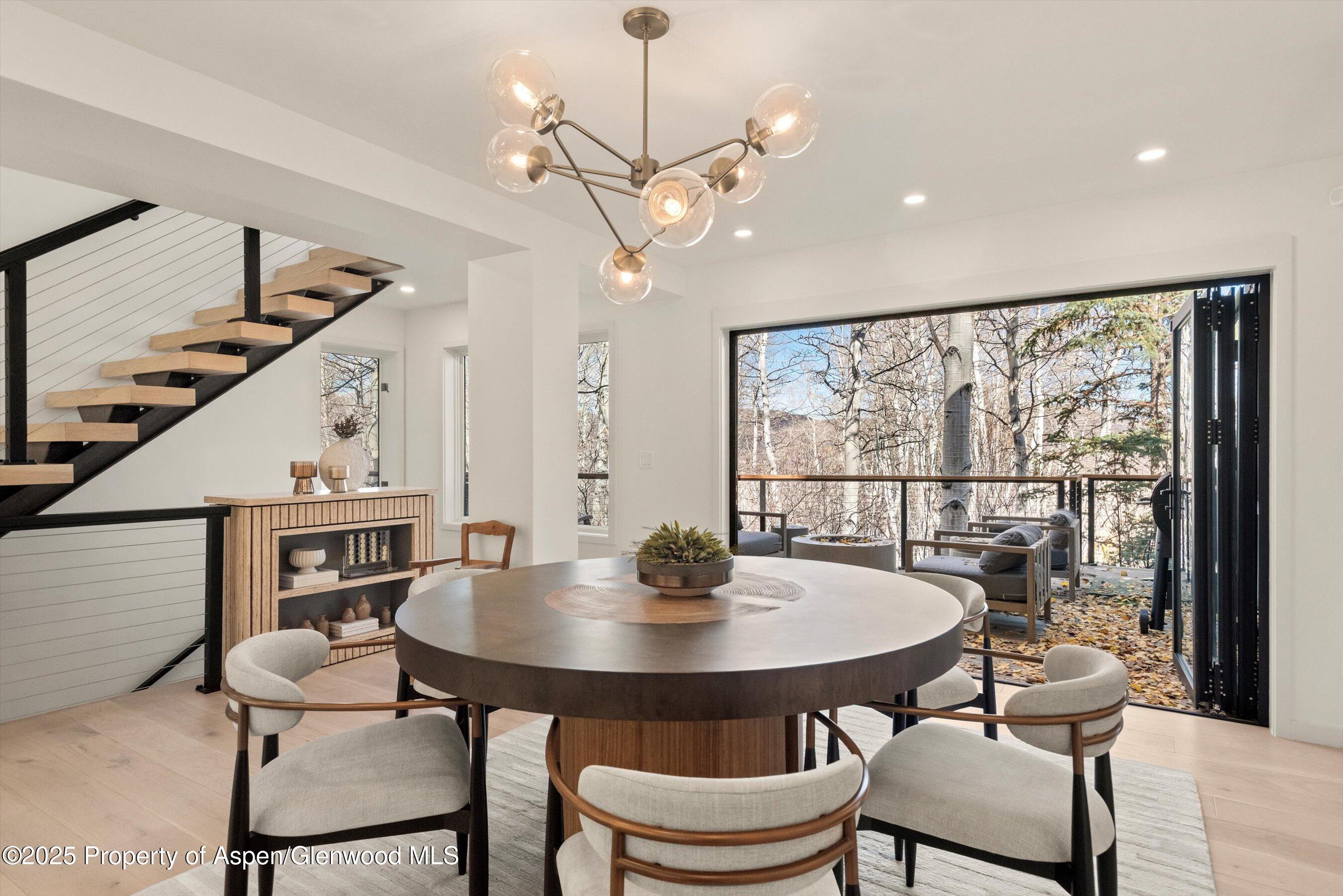 626 Faraway Road Snowmass Village, CO 81615 - Photo 5 of 23 a view of a dining room with furniture window and wooden floor
