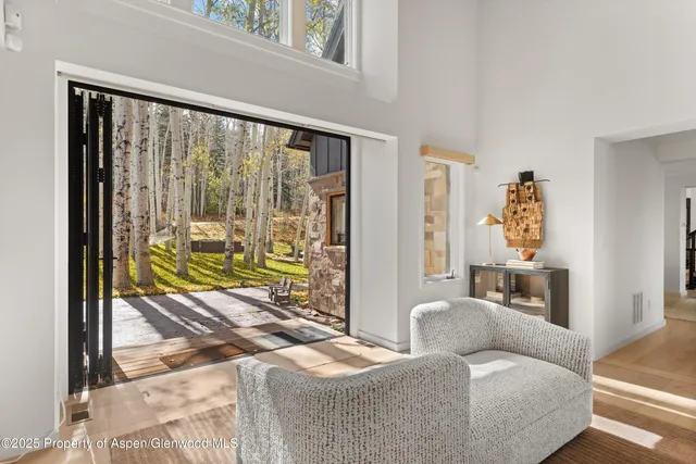 a living room with furniture and a floor to ceiling window
