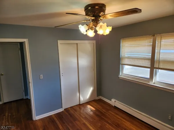 a view of a chandelier fan and wooden floor