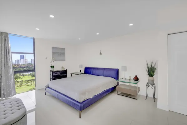 a bedroom with a bed and a potted plant