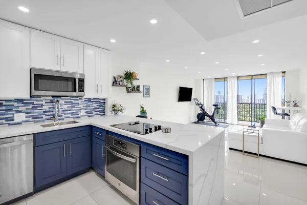 a kitchen with a sink stove and microwave