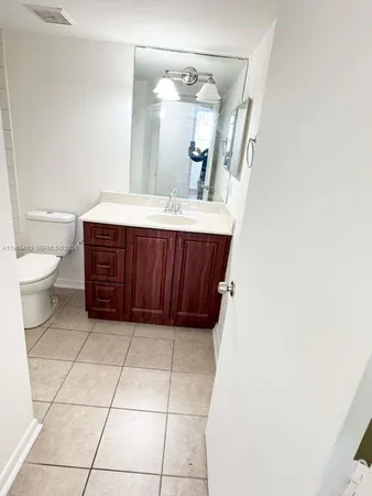a bathroom with a toilet a sink and mirror