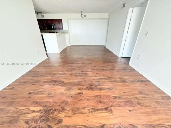 a view of a kitchen from the hallway