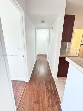 a view of a hallway view with wooden floor and staircase