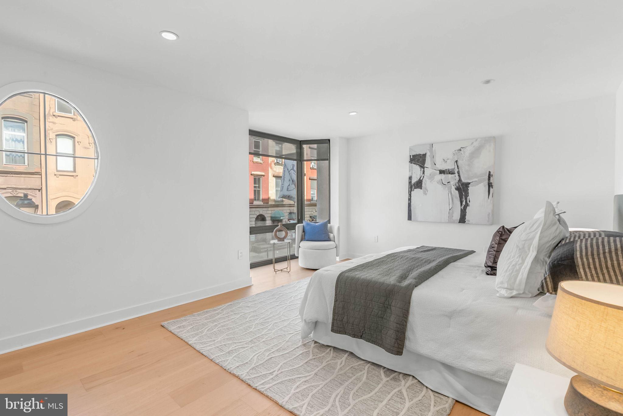 2018 Walnut Street, Unit 2018 Philadelphia, PA 19103 - Photo 23 of 52 a bedroom with a large bed and a window