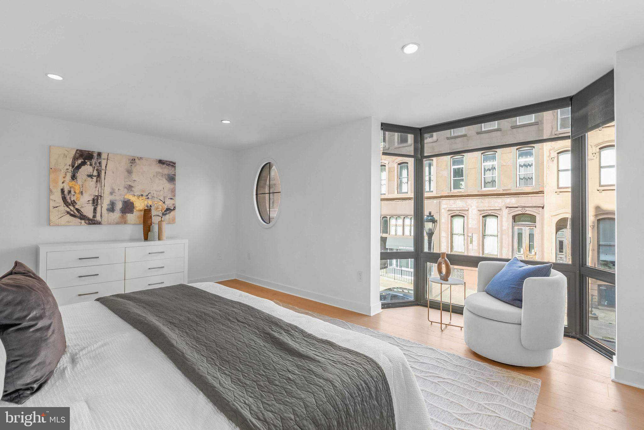 2018 Walnut Street, Unit 2018 Philadelphia, PA 19103 - Photo 25 of 52 a bedroom with furniture and a large window