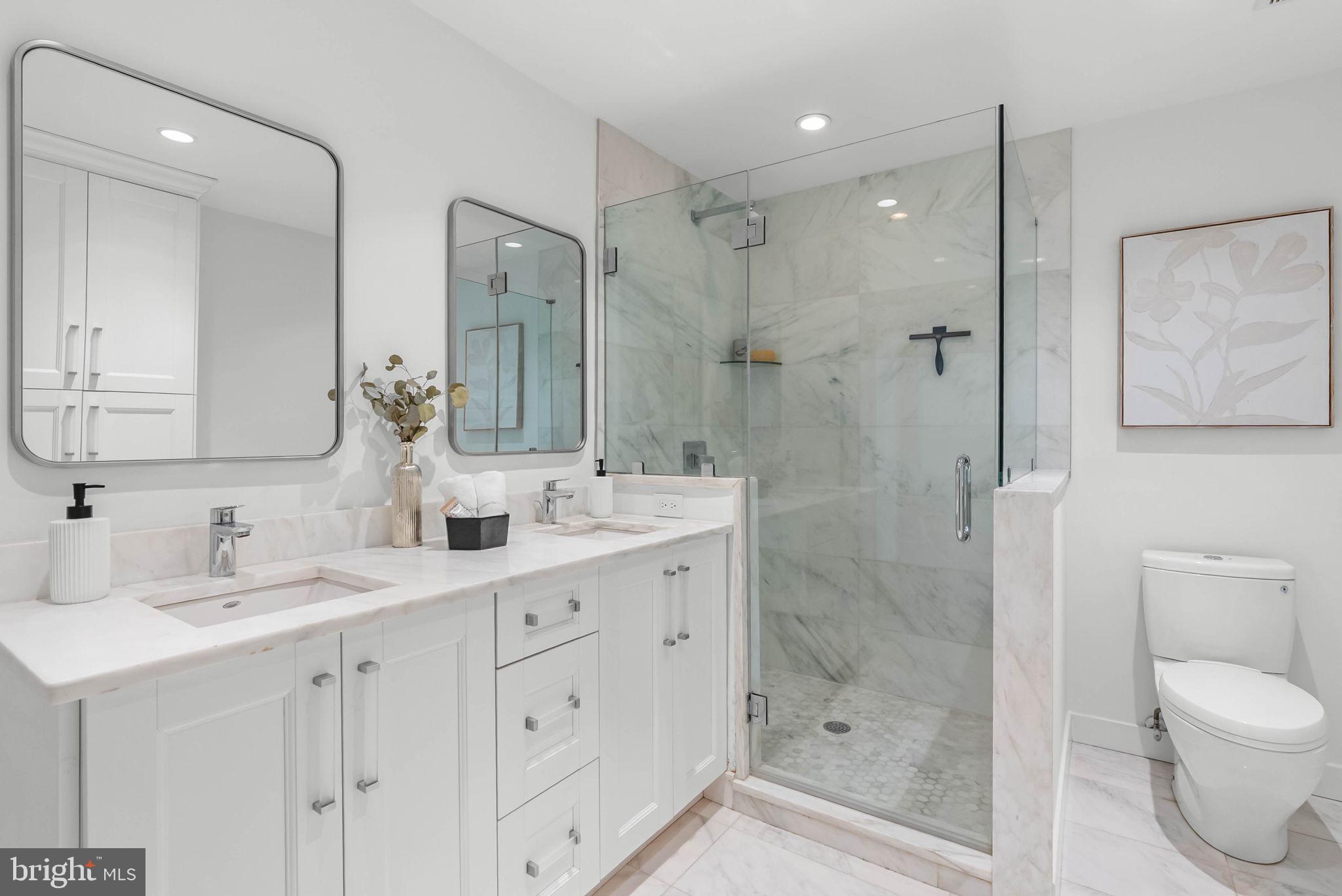 2018 Walnut Street, Unit 2018 Philadelphia, PA 19103 - Photo 29 of 52 a bathroom with a shower sink double vanity and mirror