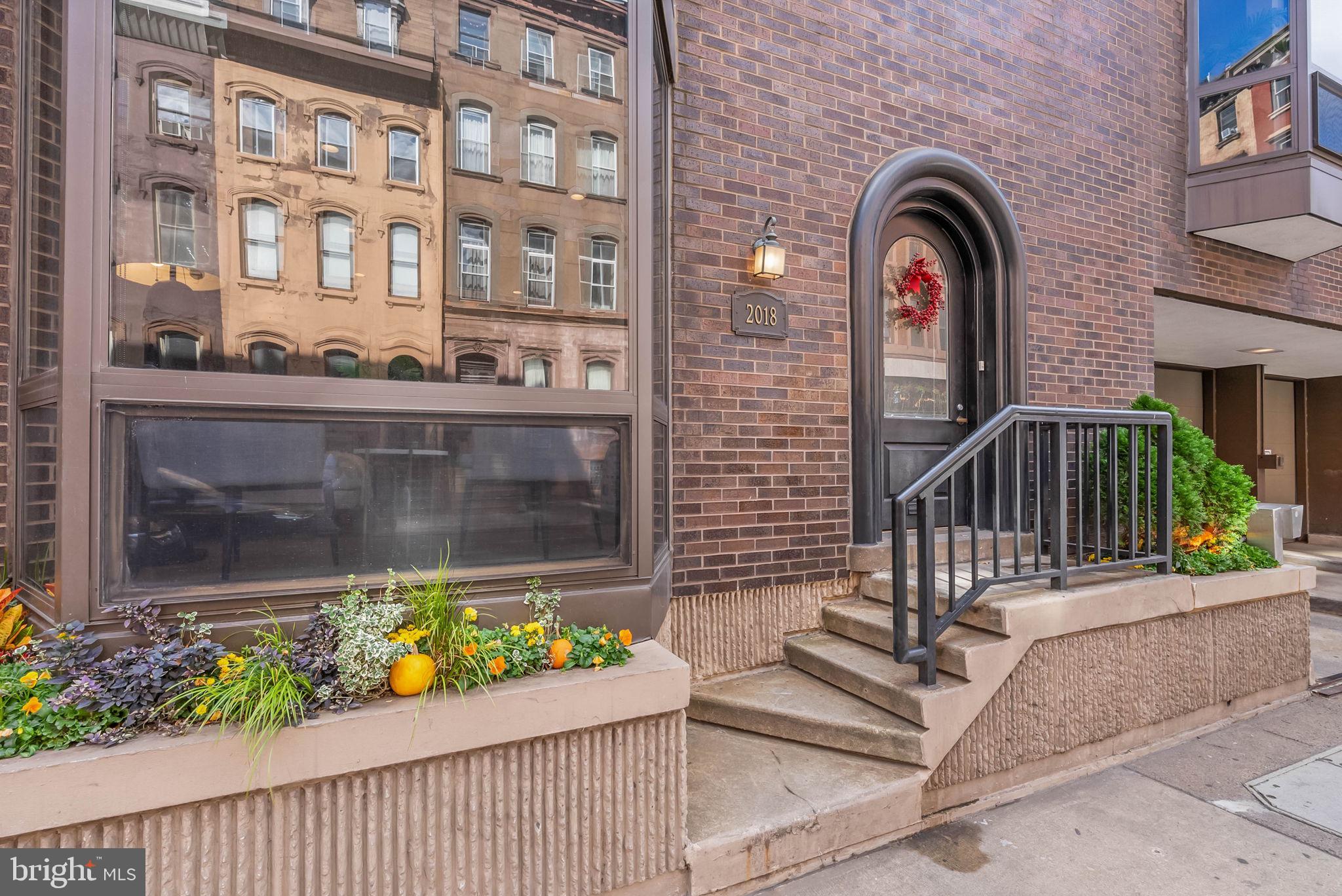 2018 Walnut Street, Unit 2018 Philadelphia, PA 19103 - Photo 3 of 52 a front view of a house with a garden