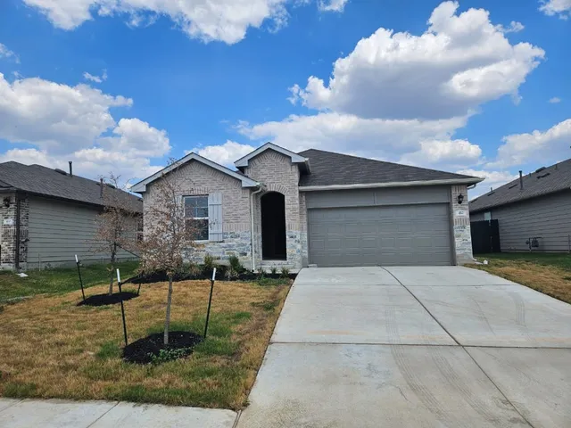 a backyard of a house with yard and barbeque oven