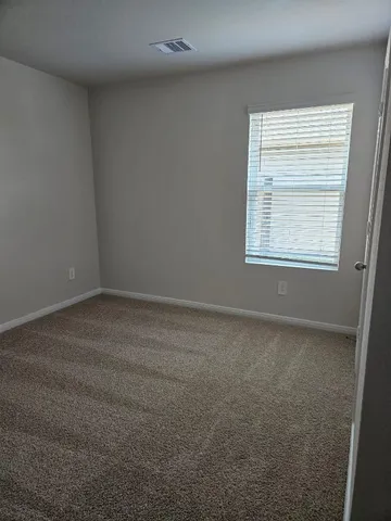 a toilet sitting in a bathroom next to a wooden wall