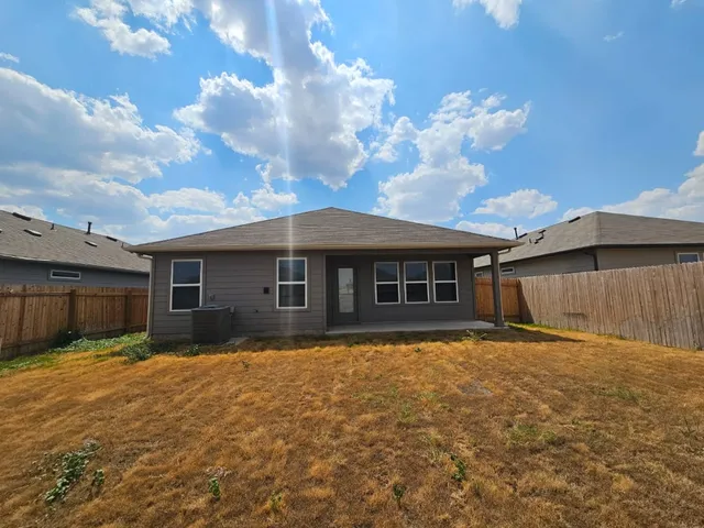 a front view of house with yard and trees