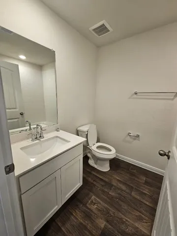 a bathroom with a toilet sink and mirror