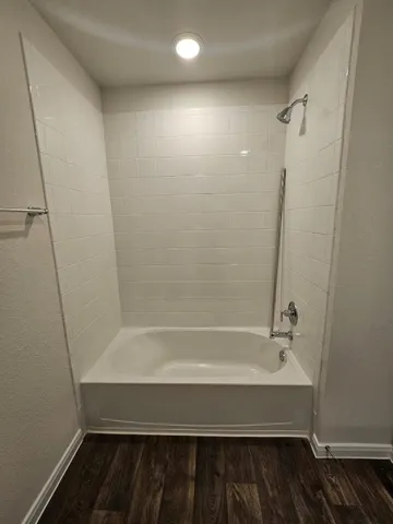 a bathroom with a bathtub and a shower