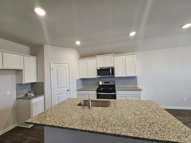 a large kitchen with a large window