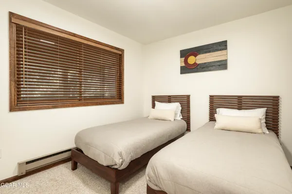 a bedroom with two beds and a window