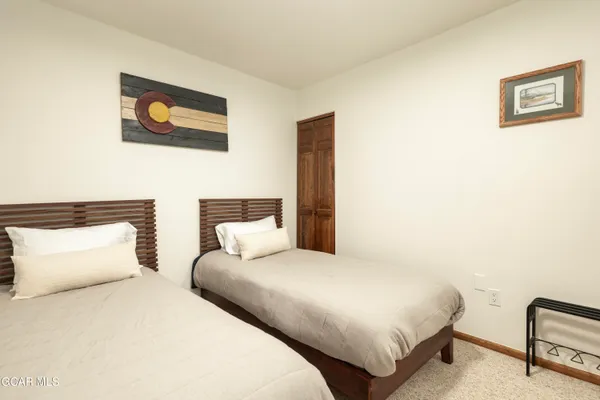 a bedroom with a bed and a lamp with the wall painting