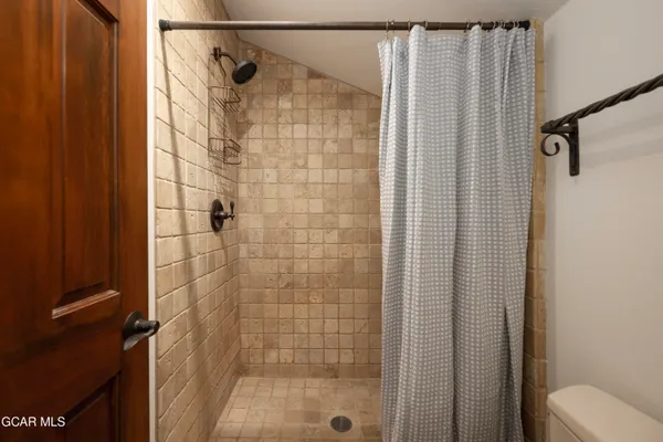 a view of hallway with furniture and a refrigerator