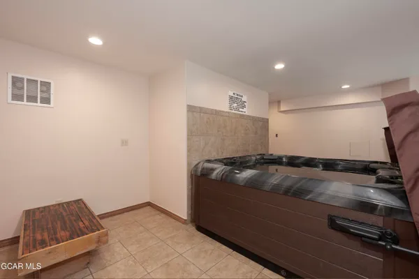 a view of a house with a backyard and a car park side of a road