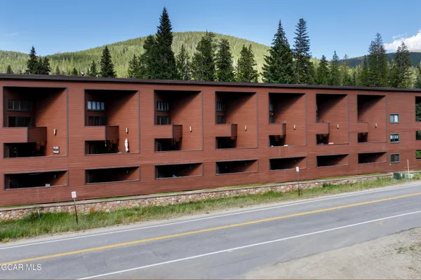 an aerial view of a house with a yard table and chairs