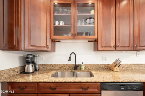 a kitchen with granite countertop a sink and cabinets