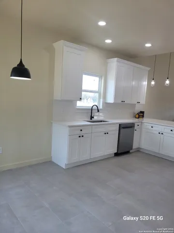 a kitchen with white cabinets