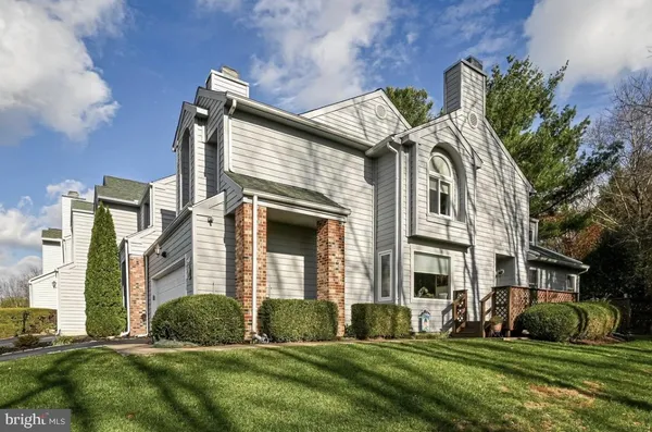 a view of a brick house with a yard