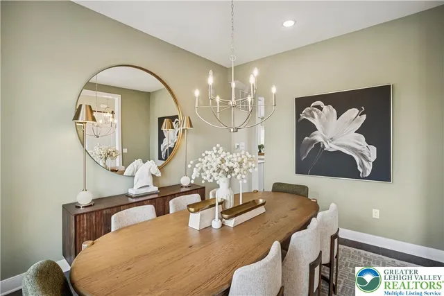 a view of a dining room with furniture a chandelier and wooden floor