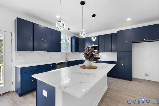 a kitchen with a sink a refrigerator and wooden cabinets
